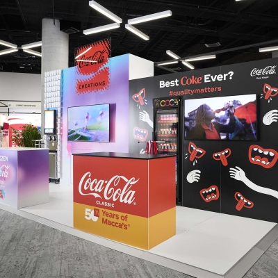 A display booth showcasing a Coca Cola vending machine, offering refreshing beverages to customers.