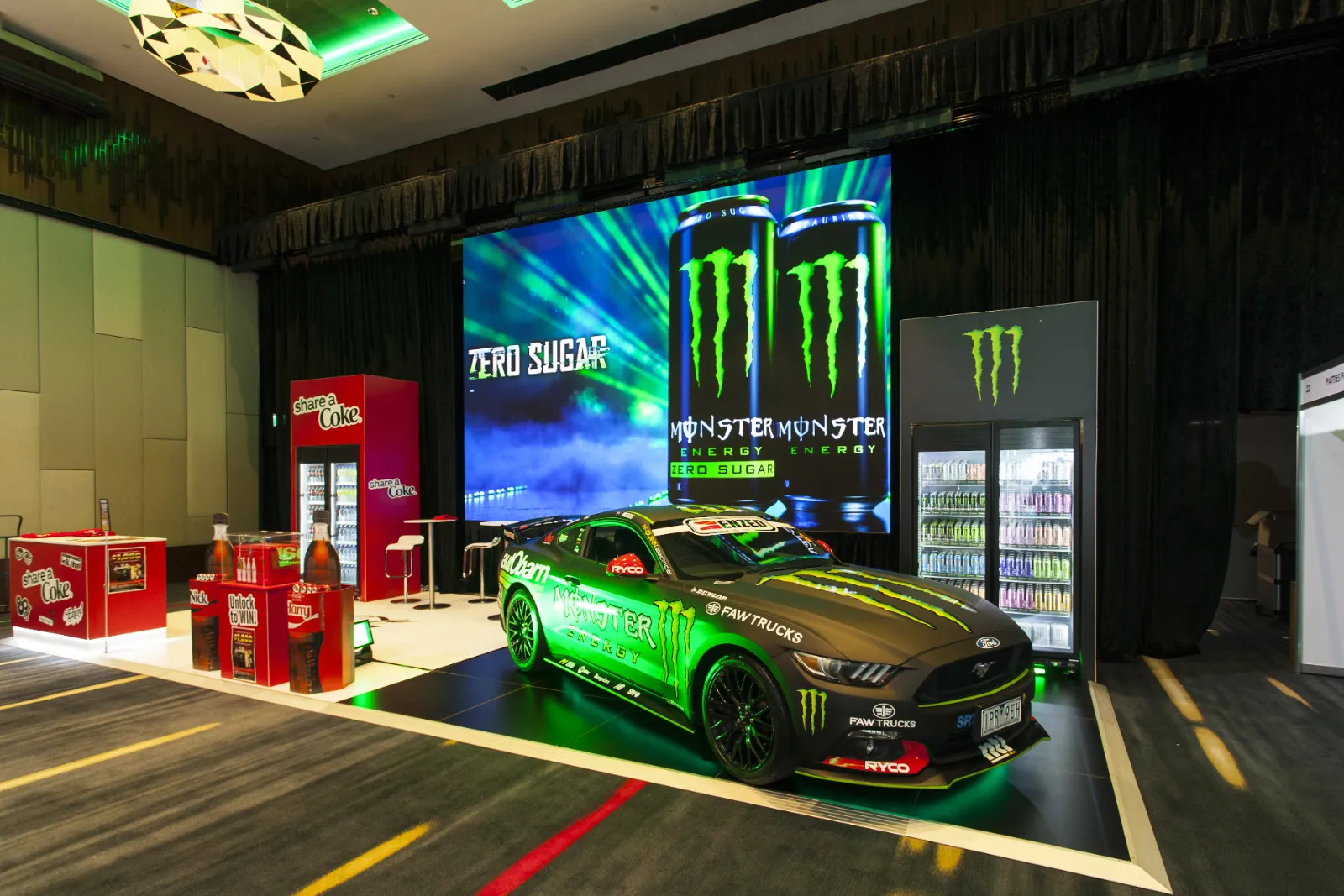 Custom temporary event environment for Monster Energy featuring exhibition stand construction, branded displays, large format graphics and product showcases.