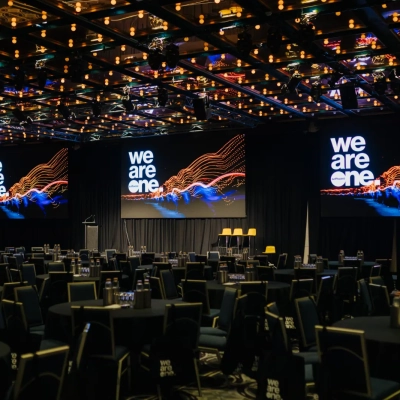 Temporary event environment featuring conference production, stage design, presentation screens and corporate event infrastructure.