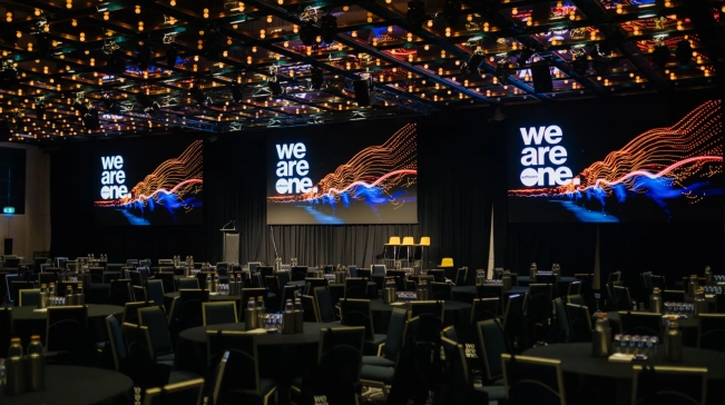 Temporary event environment featuring conference production, stage design, presentation screens and corporate event infrastructure.
