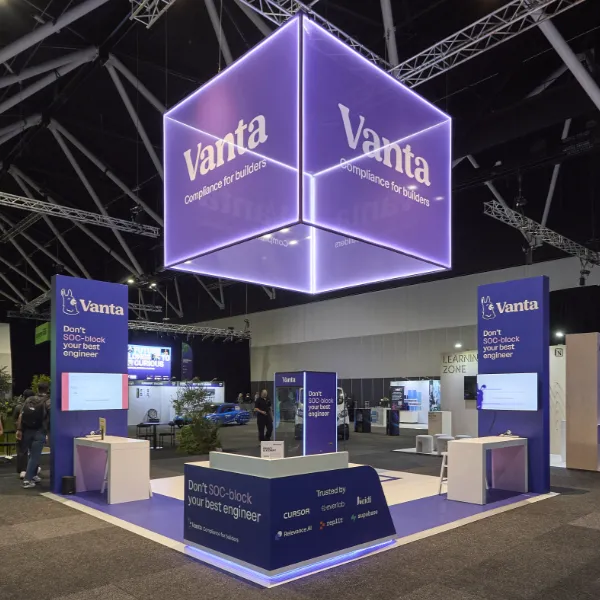 Vanta exhibition stand by Cre8 Co featuring illuminated cube signage and purple branded displays